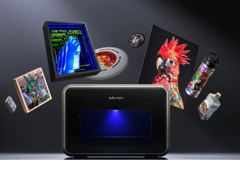 The eufyMake E1 UV printer with printed art panels, a tumbler and a bottle around it
