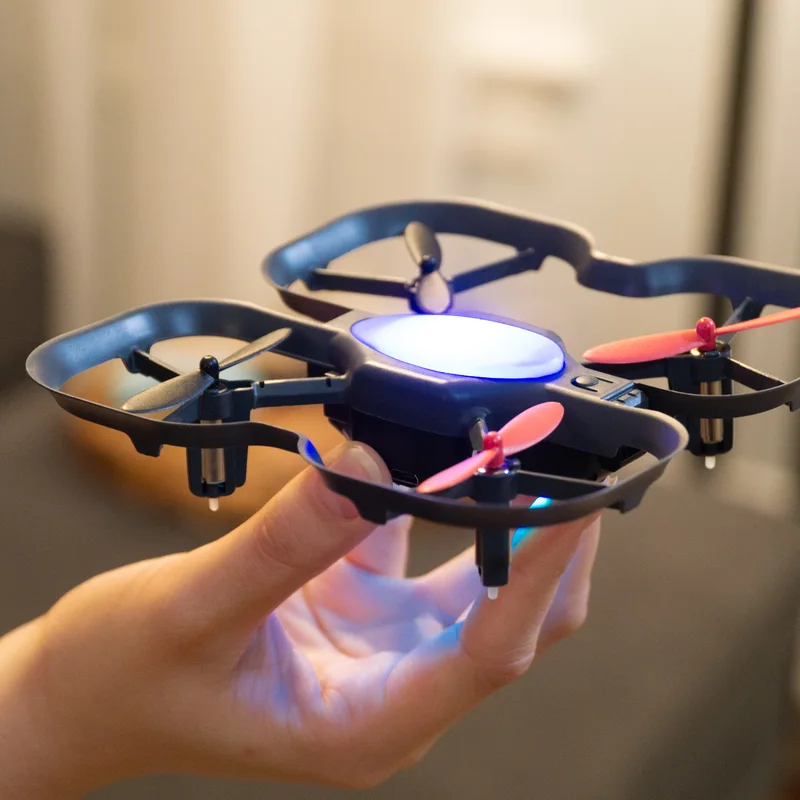 A hand holding a CoDrone EDU drone
