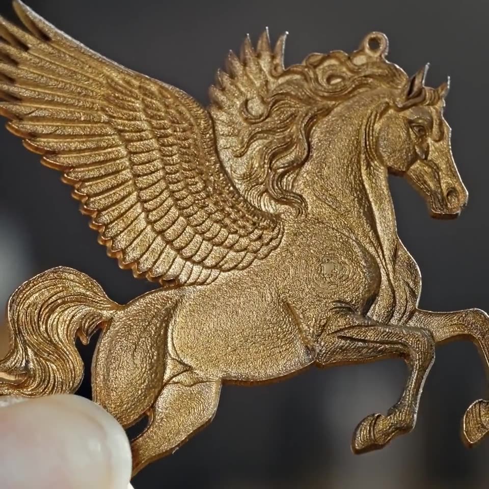 A gold pegasus, engraved and cut on an xTool machine