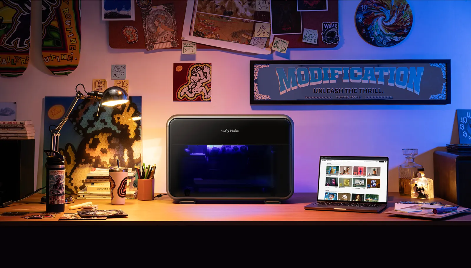 A desk studio with the eufyMake E1 and finished prints on the wall